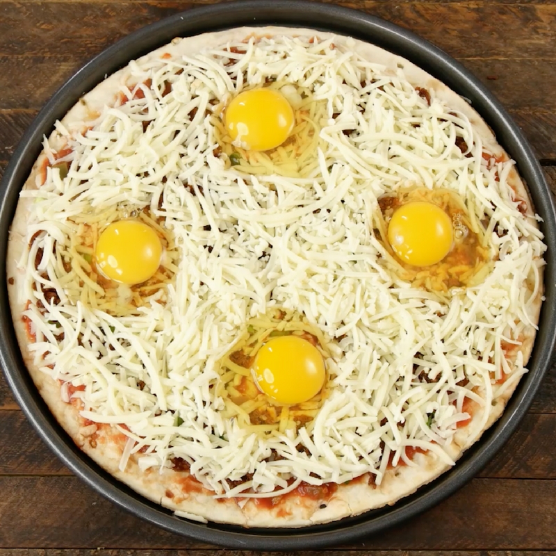 Easy Cheesy Breakfast Pizza With Sausage And Eggs – the easiest and fun breakfast that comes together in no time. All you need is a few simple recipes: your favorite sausage, pizza crust, salsa, green onions, Jack cheese, eggs, salt and pepper. It’s the perfect hearty breakfast or brunch recipe to serve to a crowd! Great for a holiday such as Easter, mother’s day or father’s day brunch. Quick and easy video recipe. | Tipbuzz.com