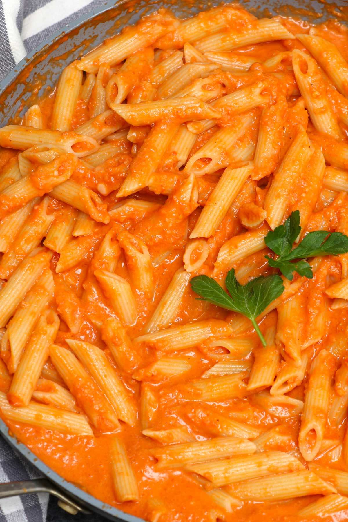 Homemade vodka sauce in a skillet mixed with penne pasta