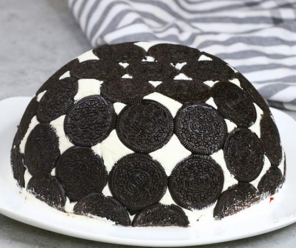 Oreo Cake - this photo shows Upside Down Oreo Cake dessert served on a plate in a beautiful, bombe-like presentation