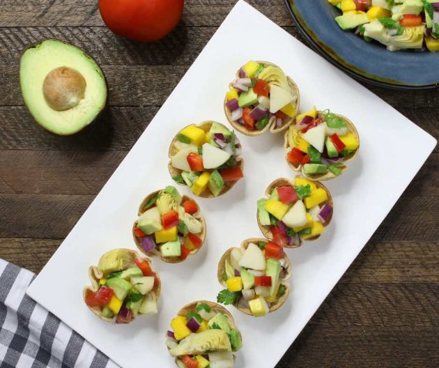 Overhead photo of a platter of heart of palm ceviche cups with recipe ingredients on the side