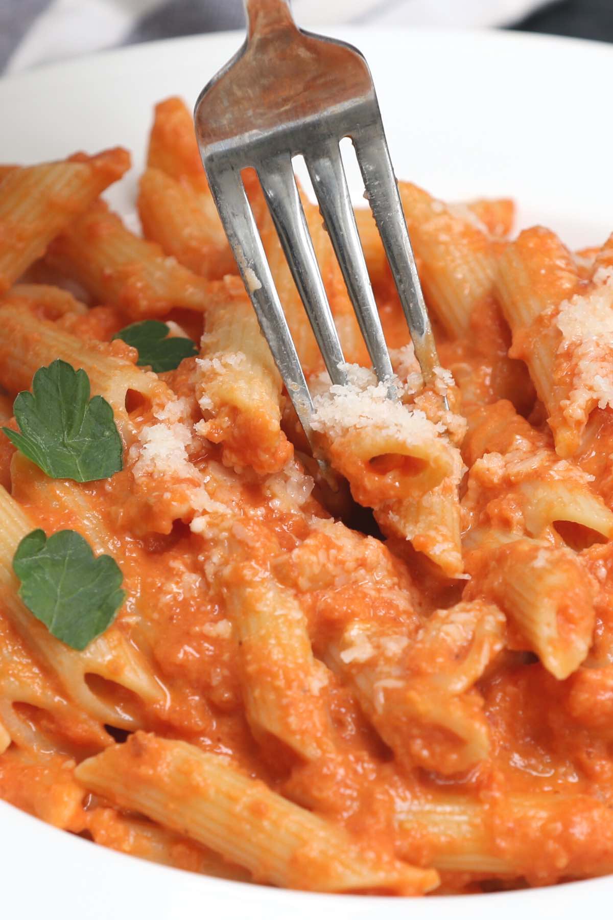 A fork digging into homemade penne alla vodka