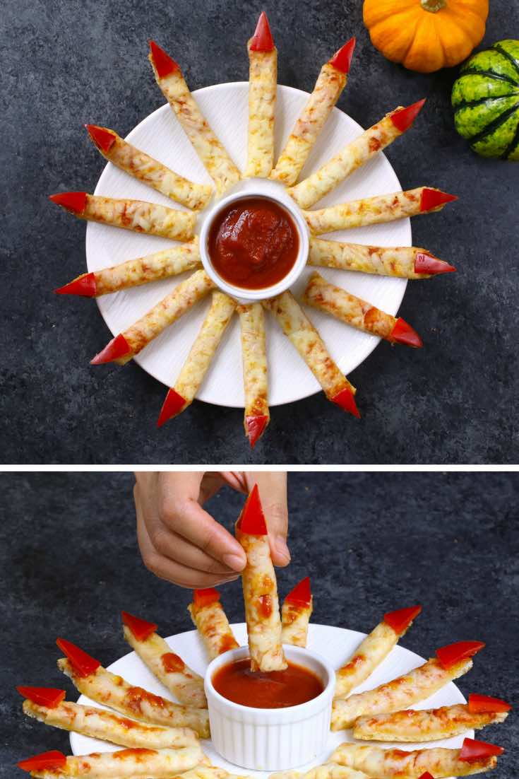 Dipping witch pizza fingers into sauce at Halloween