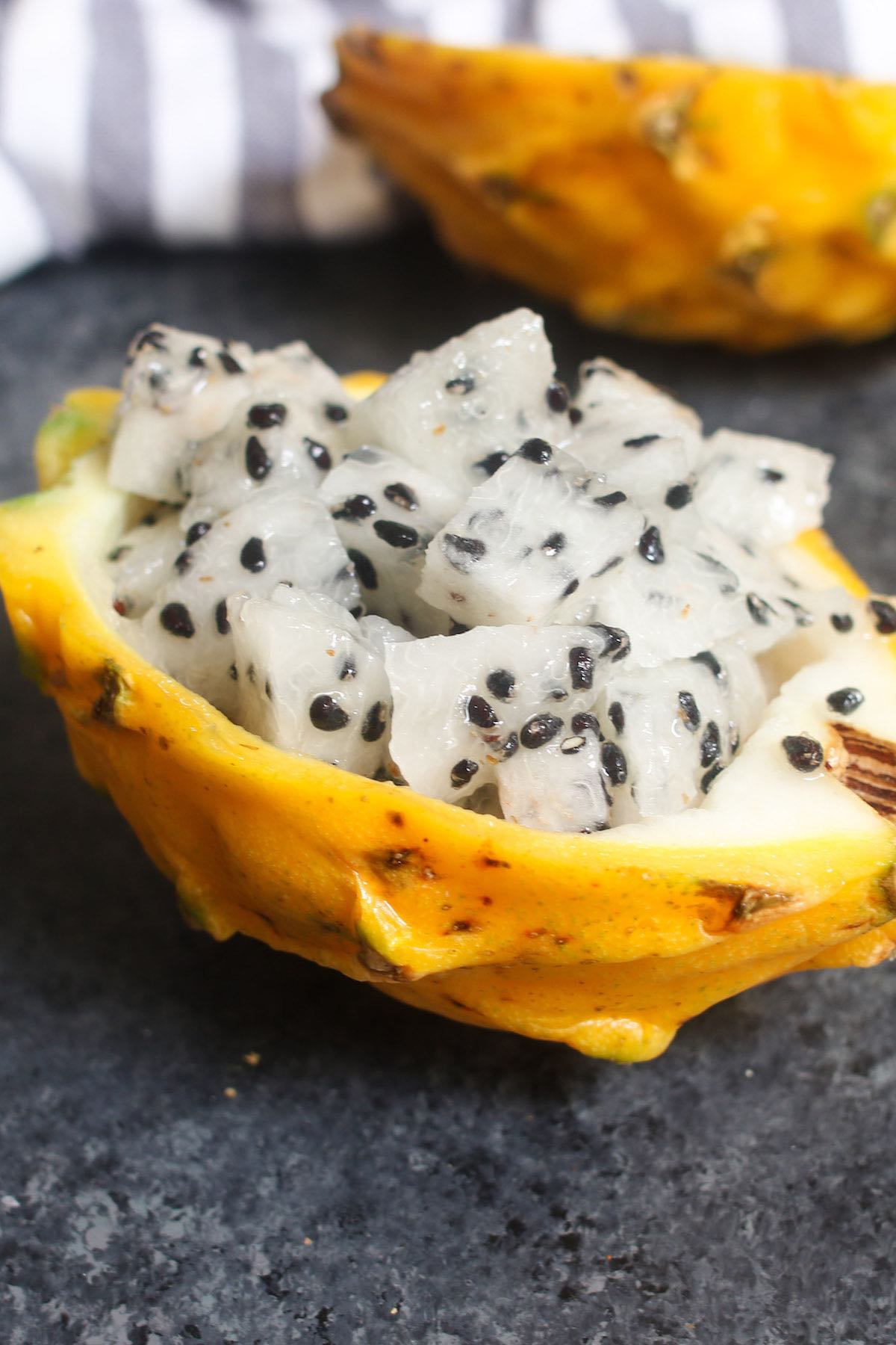 Yellow dragon fruit flesh cut into chunks and served in the skin