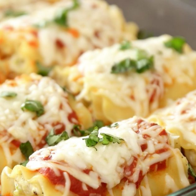 Vegetarian Lasagna Roll Ups - this closeup photo shows zucchini lasagna roll ups in a pan ready to serve with chopped fresh basil on top