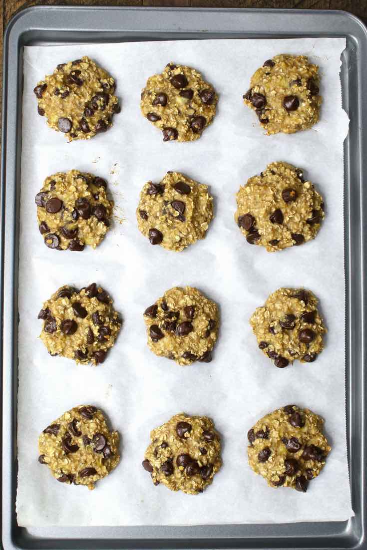 Overhead view of 12 Banana Oatmeal Chocolate Chip Cookies on a baking sheet fresh out of the oven