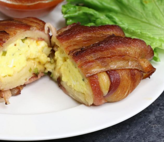 A serving of bacon covered crunchwraps cut in half on a plate with dipping sauce, perfect for brunch