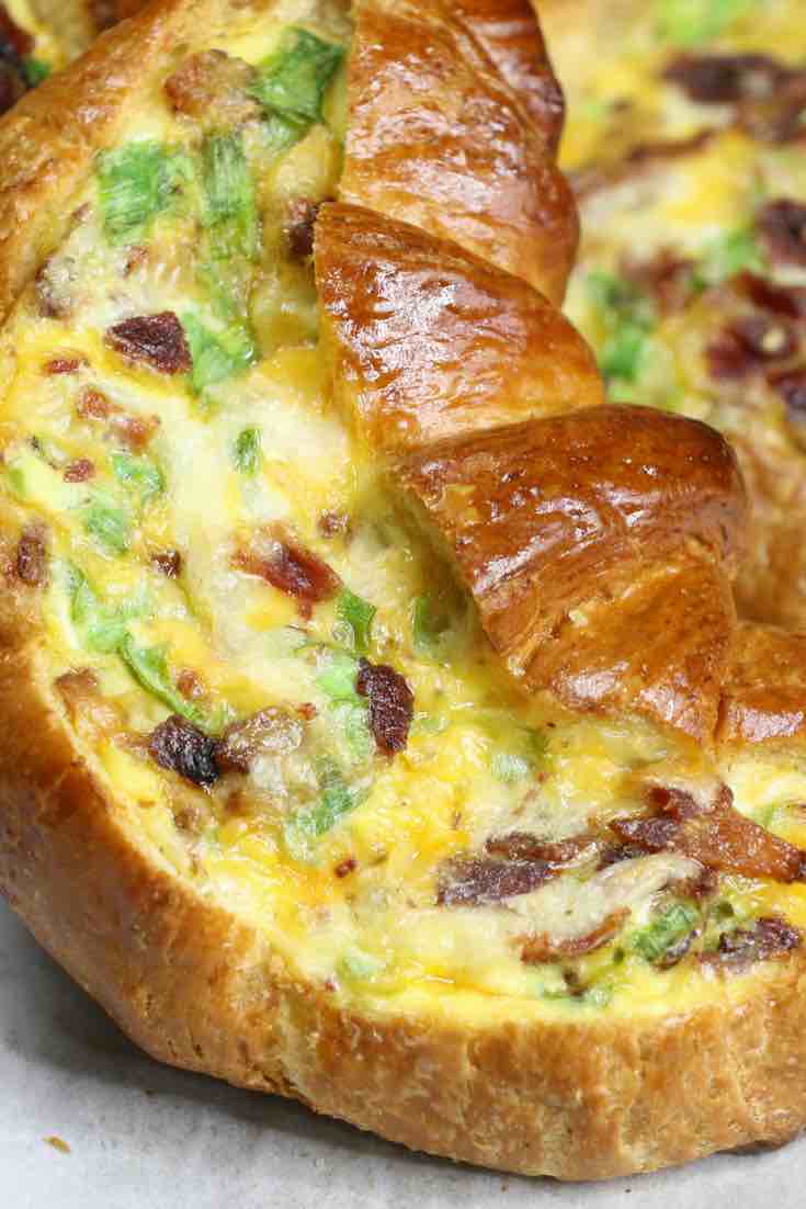 These Croissant Breakfast Boats combine crispy bacon, fluffy egg and melted cheddar cheese baked in croissant breakfast boats! A quick and easy recipe that’s ready in 30 minutes and feeds a crowd! Perfect for breakfast and brunch. So delicious! Video recipe. | Tipbuzz.com