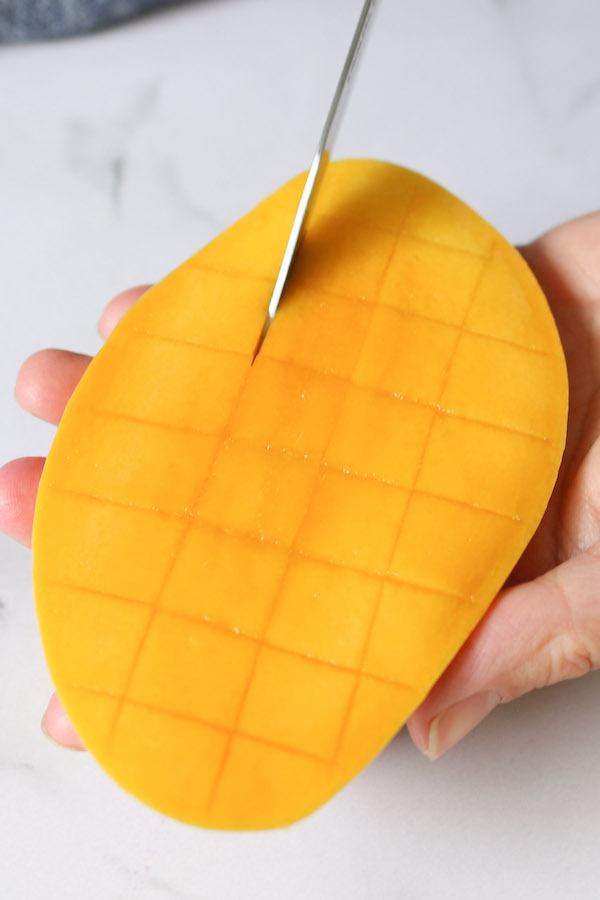 Cutting up a mango into cubes