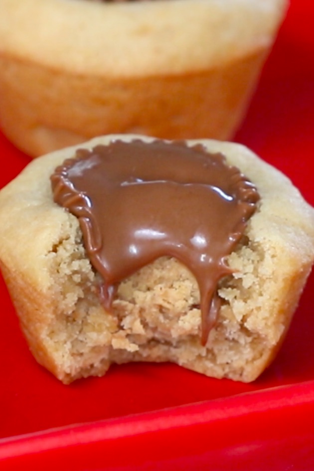 A bite of a peanut butter cup cookie while it's still slightly warm