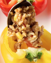Stuffing a yellow bell pepper with delicious beef and rice filling