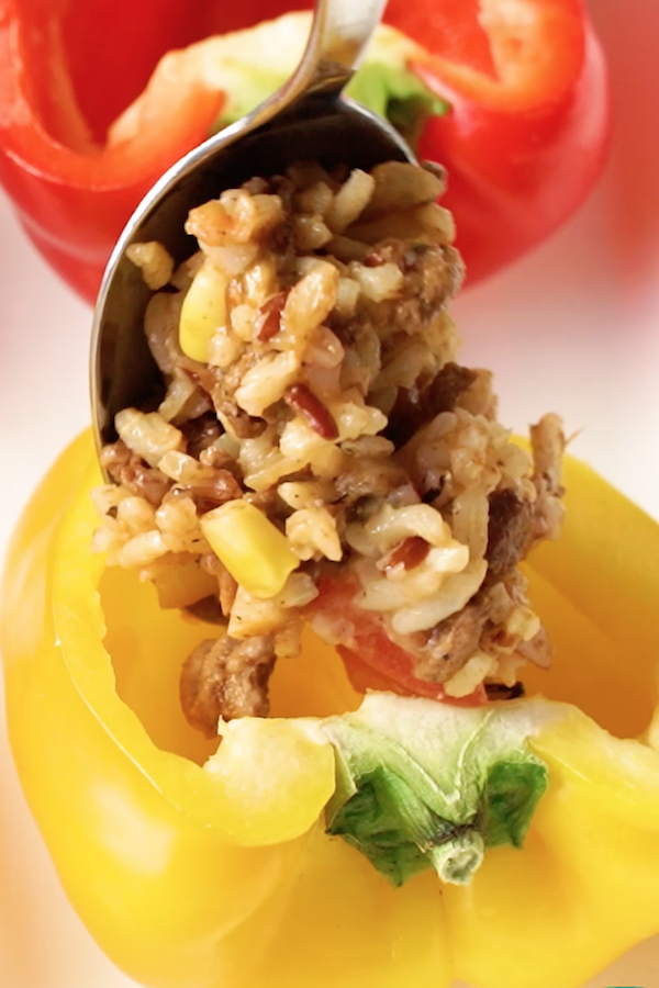 Stuffing a yellow bell pepper with delicious beef and rice filling
