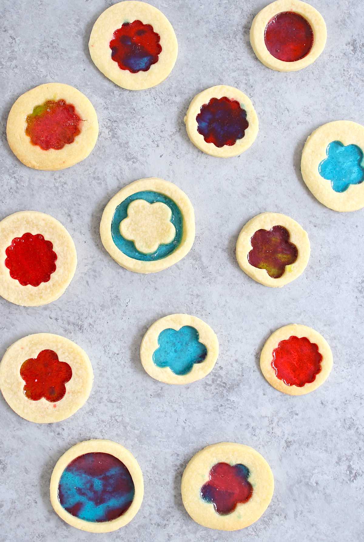 Display of stained glass cookies with different colors and shapes.
