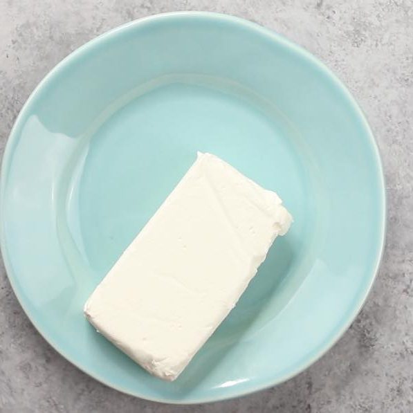 An 8 ounce brick of cream cheese that requires softening before use in recipes such as cheesecake or cheese dips